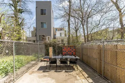 a patio with a table and chairs on a fence at 5BR - Sleeps 14 - Street Parking - 10 min to DT in Philadelphia