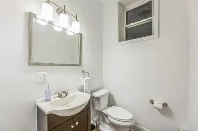 a white bathroom with a sink and a toilet at Charming 1BR in Center City that Sleeps 4 with Fast WiFi in Philadelphia