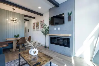 a living room with a fireplace and a table at 1 BR Across from Fairmount Park -10 mins to DT (D) in Philadelphia