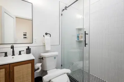 a bathroom with a toilet and a glass shower at 1 BR Across from Fairmount Park -10 mins to DT (D) in Philadelphia