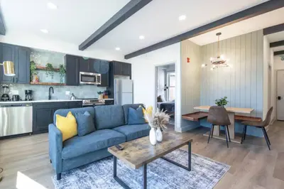 a living room with a blue couch and a table at 1 BR Across from Fairmount Park -10 mins to DT (D) in Philadelphia