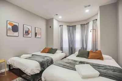 a bedroom with two beds and a window at Charming Center City 2BR - Sleeps 8 people in Philadelphia