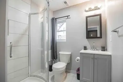 a bathroom with a shower and a toilet and a sink at Charming Center City 2BR - Sleeps 8 people in Philadelphia