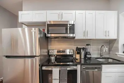 a kitchen with a stainless steel refrigerator and microwave at Charming Center City 2BR - Sleeps 8 people in Philadelphia