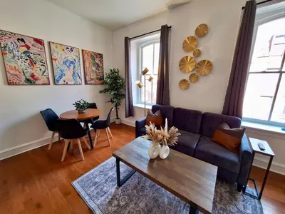 a living room with a couch and a table at Brand New Center City 1BR with King Bed and Fast WiFi in Philadelphia
