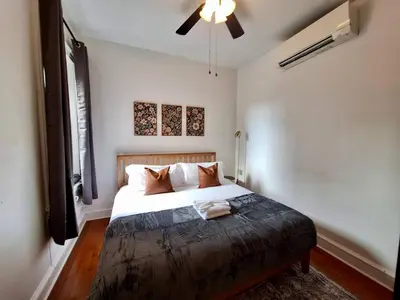 a bedroom with a large white bed with a ceiling fan at Brand New Center City 1BR with King Bed and Fast WiFi in Philadelphia