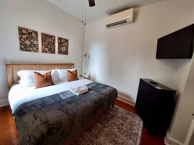 a bedroom with a bed and a flat screen tv at Brand New Center City 1BR with King Bed and Fast WiFi in Philadelphia