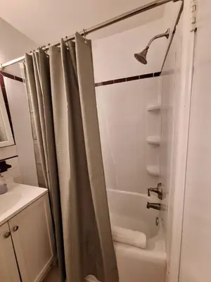a bathroom with a shower with a shower curtain at Brand New Center City 1BR with King Bed and Fast WiFi in Philadelphia