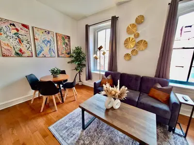 a living room with a couch and a table at Brand New Center City 1BR with King Bed and Fast WiFi in Philadelphia