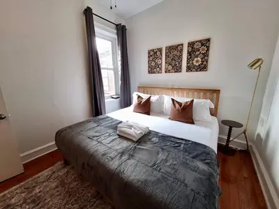a bedroom with a large bed and a window at Brand New Center City 1BR with King Bed and Fast WiFi in Philadelphia