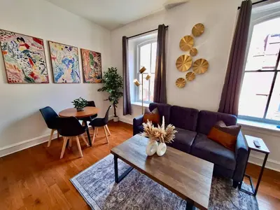 a living room with a couch and a table at Brand New Center City 1BR with King Bed and Fast WiFi in Philadelphia