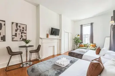 a living room with two beds and a fireplace at New Studio in Center City that Sleeps 4 with Fast Wifi in Philadelphia