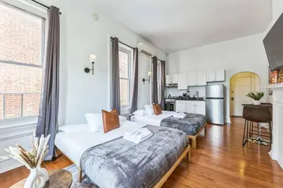 two beds in a room with a kitchen at New Studio in Center City that Sleeps 4 with Fast Wifi in Philadelphia