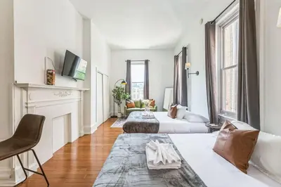 a living room with two beds and a fireplace at New Studio in Center City that Sleeps 4 with Fast Wifi in Philadelphia