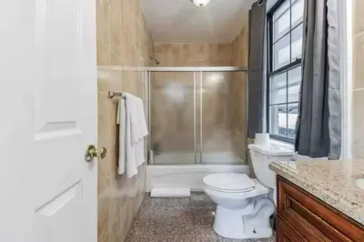 a bathroom with a shower and a toilet and a sink at 1BR Across Convention Center in Philadelphia