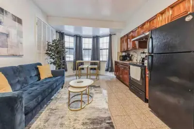 a kitchen and living room with a large black refrigerator at 1BR Across Convention Center in Philadelphia
