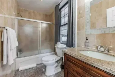 a bathroom with a toilet and a shower and a sink at 1BR Across Convention Center in Philadelphia