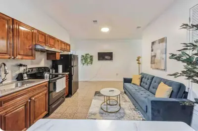 a kitchen and living room with a blue couch at 1BR Across Convention Center in Philadelphia