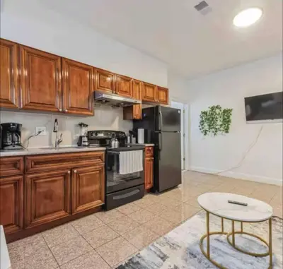 a kitchen with wooden cabinets and stainless steel appliances at 1BR Across Convention Center in Philadelphia