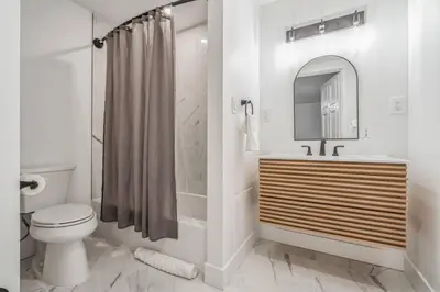 a bathroom with a toilet and a sink and a mirror at Large Historical 1BR Center City that Sleeps 4 in Philadelphia