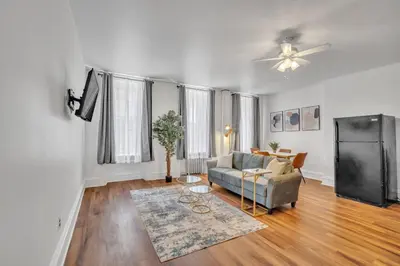 a living room with a couch and a tv at Large Historical 1BR Center City that Sleeps 4 in Philadelphia