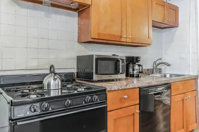 a kitchen with a stove and a microwave at Large Historical 1BR Center City that Sleeps 4 in Philadelphia