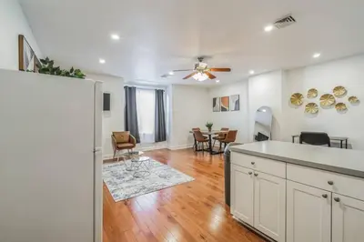 an open kitchen and living room with a dining room at Huge and Sunny 1BR in Center City in Philadelphia