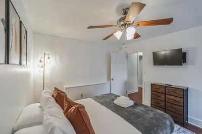 a bedroom with a bed and a ceiling fan at Huge and Sunny 1BR in Center City in Philadelphia