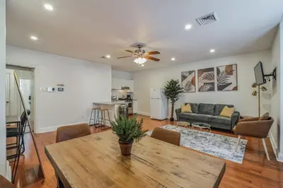 a living room with a table and a couch at Huge and Sunny 1BR in Center City in Philadelphia