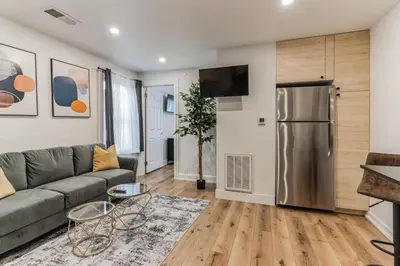 a living room with a couch and a refrigerator at Large and Cozy Center City 1BR in Philadelphia