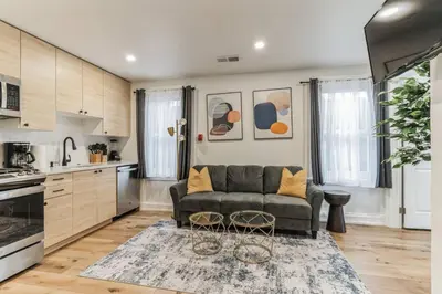 a living room with a couch and a kitchen at Large and Cozy Center City 1BR in Philadelphia