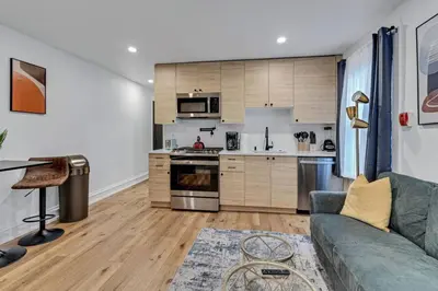 a living room with a couch and a kitchen at Large and Cozy Center City 1BR in Philadelphia