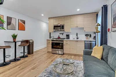 a living room with a couch and a kitchen at Large and Cozy Center City 1BR in Philadelphia