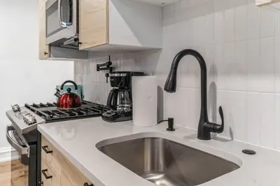 a kitchen with a sink and a stove at Large and Cozy Center City 1BR in Philadelphia