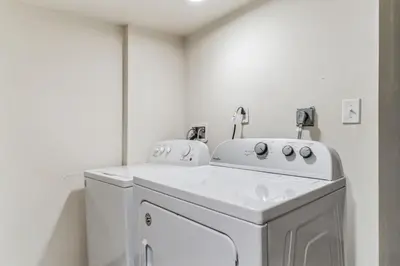 a white laundry room with a washer and dryer at Large and Cozy Center City 1BR in Philadelphia