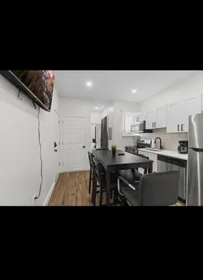 a kitchen with a table and chairs in a room at Modern 2 bedroom 1 bath unit 2 Near Airport, Xfinity Arena and Eagles Stadium in Philadelphia