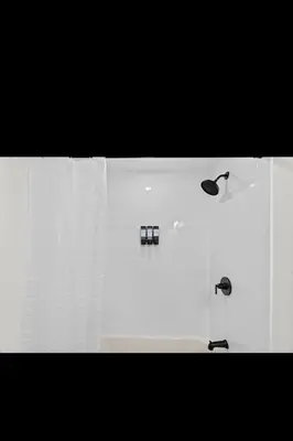 a white bathroom with a shower and a sink at Modern 2 bedroom 1 bath unit 2 Near Airport, Xfinity Arena and Eagles Stadium in Philadelphia