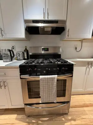 a kitchen with a stove with a towel on it at Studio Apartment with Garden Jersey City in Jersey City
