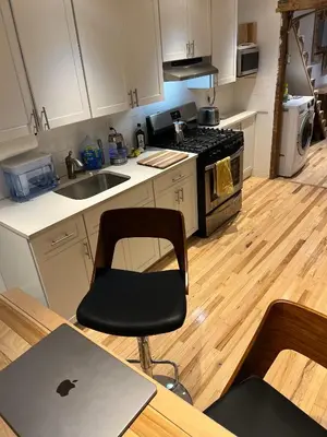 a kitchen with an apple laptop on a table at Studio Apartment with Garden Jersey City in Jersey City
