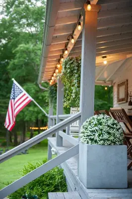 an american flag on the porch of a house at A perfect couples fall getaway in Hawley