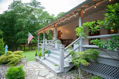 a house with a porch with an american flag at A perfect couples fall getaway in Hawley
