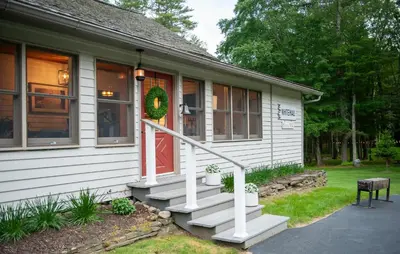 a house with a christmas wreath on the door at A perfect couples fall getaway in Hawley