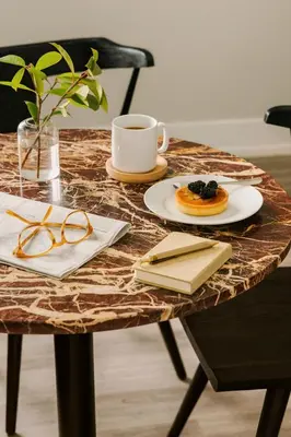 a table with a plate of food and a cup of coffee at Sosuite at The Ovation - Ave of The Arts in Philadelphia