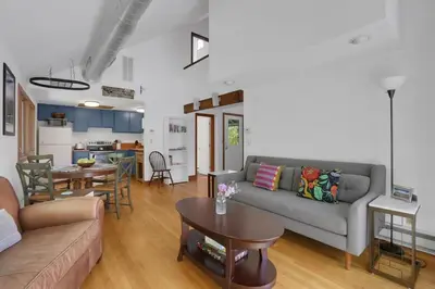 a living room with a couch and a table at House Under The Cliff in New Paltz