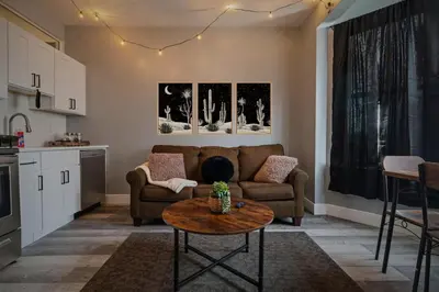 a living room with a couch and a table at Cozy Desert Den 10 Min Downtown& 6 Min Brewerytown in Philadelphia