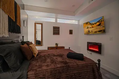 a bedroom with a large bed and a window at Cozy Desert Den 10 Min Downtown& 6 Min Brewerytown in Philadelphia