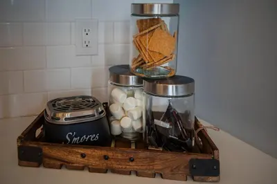 a wooden tray with food and other items on a counter at Cozy Desert Den 10 Min Downtown& 6 Min Brewerytown in Philadelphia