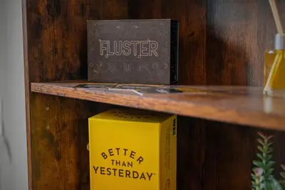 a yellow book sitting on a wooden shelf at Cozy Desert Den 10 Min Downtown& 6 Min Brewerytown in Philadelphia