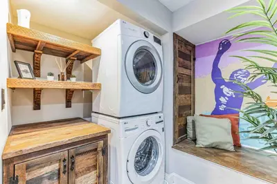 a laundry room with a washer and dryer at Large Bi-Level 3BR w Patio - 10 min to DT in Philadelphia