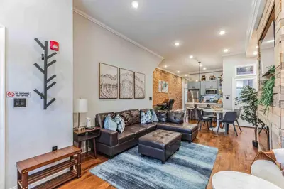 a living room with a couch and a table at Large Bi-Level 3BR w Patio - 10 min to DT in Philadelphia